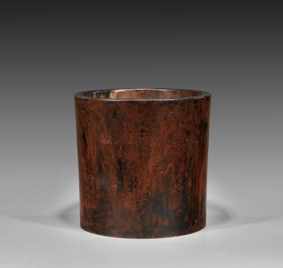 MASSIVE ANTIQUE HUANG HUALI BRUSHPOT: MASSIVE ANTIQUE HUANG HUALI BRUSHPOTMassive and probably antique, Chinese huang huali wood brushpot; of wide simple cylindrical form showing fine grain patterning throughout; H: 12 1/4"