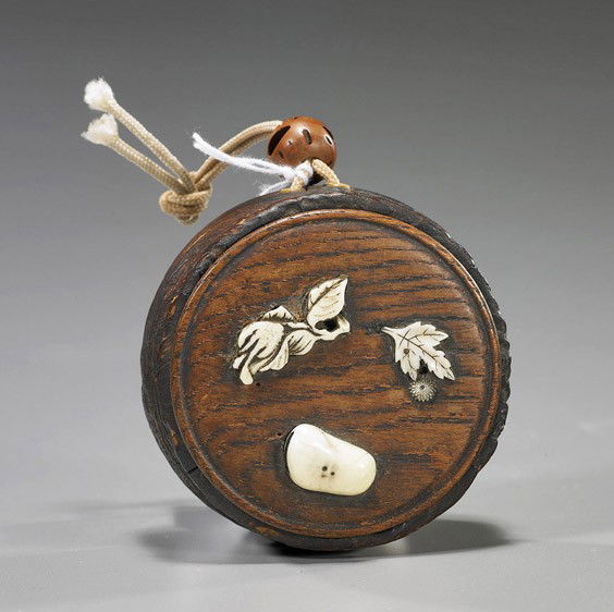 Unusual Antique Circular Wood Inro: Unusual Antique Circular Wood InroAntique circular wood inro; the cover with ivory and mother-of-pearl appliqué Buddha's hand citron, pebble and leaf with blossom (some cracks and wear), 19th Century