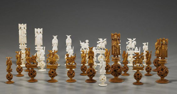 Chinese Carved Ivory Puzzleball Chess Set: Chinese Carved Ivory Puzzleball Chess SetChinese carved ivory chess set; comprised of 32 detailed pieces: each with a puzzleball carved to the base; half stained, no board; H: 6 3/4" (tallest)