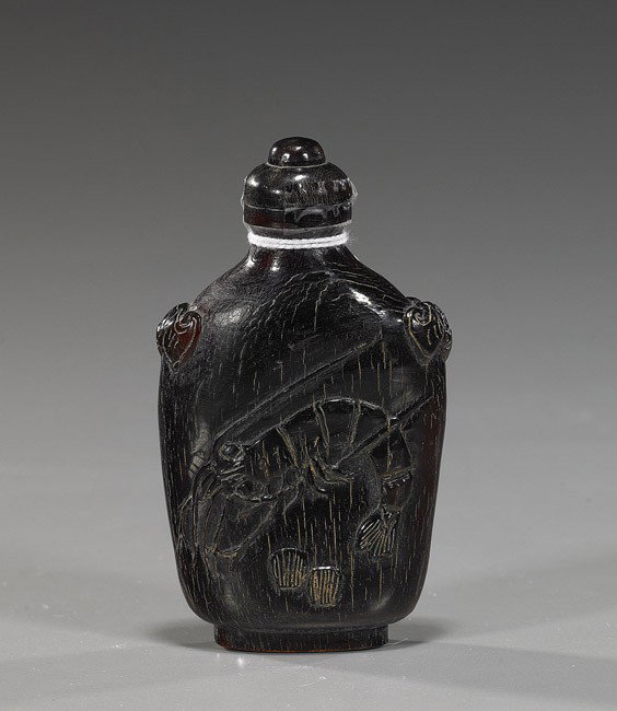 Chinese Carved Horn Snuff Bottle: Chinese Carved Horn Snuff Bottle Chinese carved horn snuff bottle; of rounded rectangular form with relief designs of shrimp to the front and back, bats at the shoulders, matching stopper; H: 3 1/2"