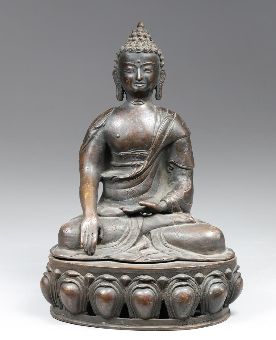Antique Nepalese Bronze Seated Bodhisattva Figure: Antique Nepalese bronze seated Bodhisattva figure with hands in mudra dressed in flowing robes adorned with incised emblems pendulous ears with elaborate conical hair seated atop pierced lotus base wi