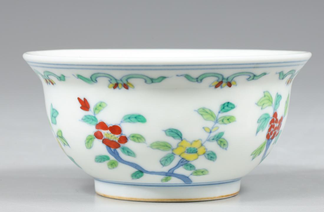 Antique Chinese Enameled Porcelain Wine Cup: Beautifully painted antique circa 18th century Chinese enameled porcelain wine cup, the exterior finely decorated with seasonal flowers with leaves on branches, six character apocryphal Chenghua mark