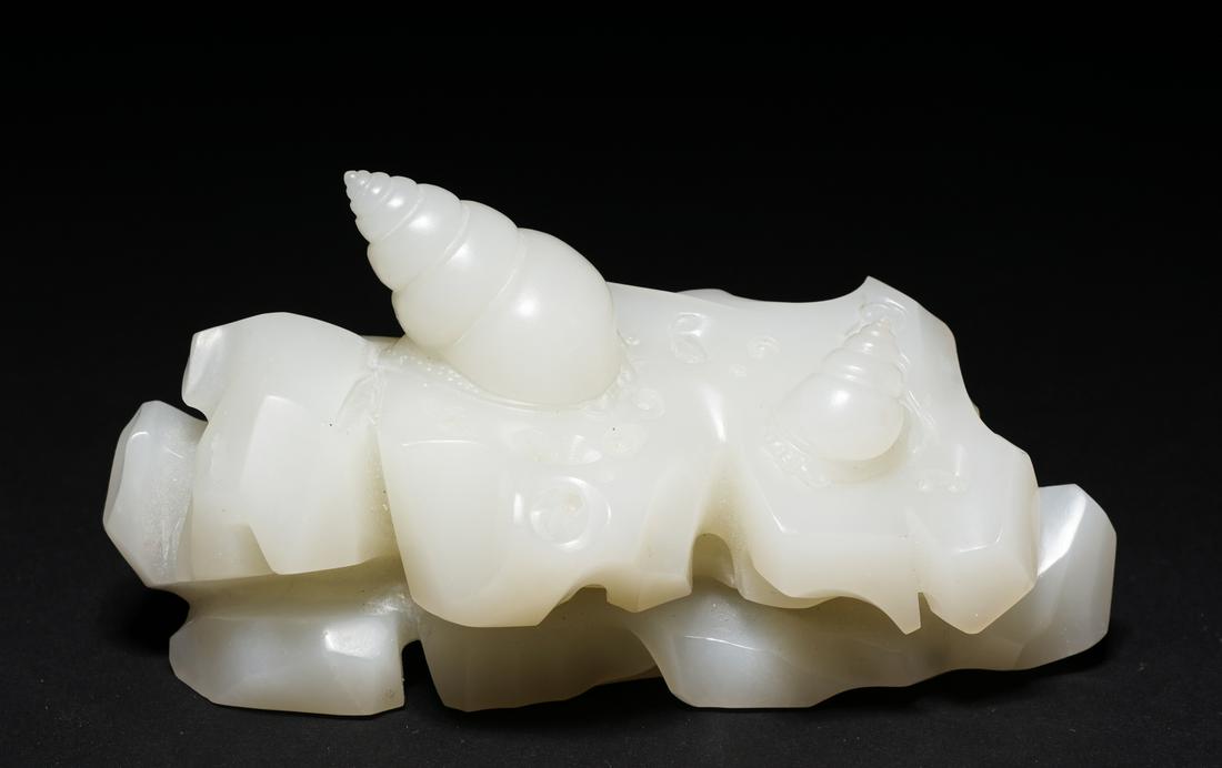 Very Fine Chinese Late Qing Dynasty Mutton Fate Jade Brush Rest: Very fine Chinese mutton fat nephrite jade brush rest; finely detailed shoreline of rocky outcrop deeply carved with two conical seashells adhering to the surface, ideally suited as a brush rest for t