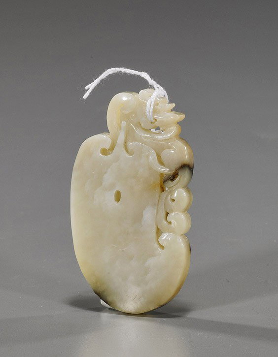 Chinese Archaistic Carved Oval Jade: Chinese Archaistic Carved Oval Jade Archaistic Chinese carved jade; of somewhat oval form, burial-style piece with openwork hydra, white with some brown spots; L: 3"