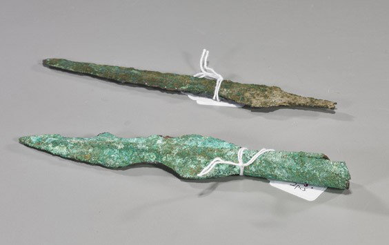 Two Archaic Chinese Bronze Spear Points: Two Archaic Chinese Bronze Spear Points Two archaic Chinese bronze spear points: Warring States/Han Dynasty (both heavily encrusted and with chips); L: 7 1/4" (longest)