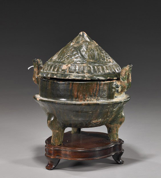 Han Dynasty Green Glazed Pottery Censer: Han Dynasty Green Glazed Pottery Censer Chinese Han Dynasty green, glazed pottery tripod censer; cylindrical with two loop handles and with moulded mountain-form cover (various chips); H: 8 1/2", wood