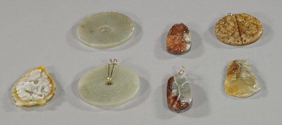 Group of Seven Chinese Carved Jades: Group of Seven Chinese Carved Jades Group of 7 Chinese jades: 2 celadon color bi- one with yellow gold bale, the other with tiny frits; leaf form jadeite dragon pendant; jadeite double gourd pendant; 