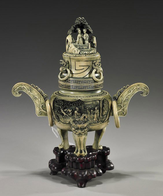 Chinese Carved Ivory Tripod Koro: Chinese Carved Ivory Tripod KoroChinese sectional carved and stained ivory tripod koro and cover; with high relief figural scenes to the front and back and with openwork landscape design finial, 6 loo