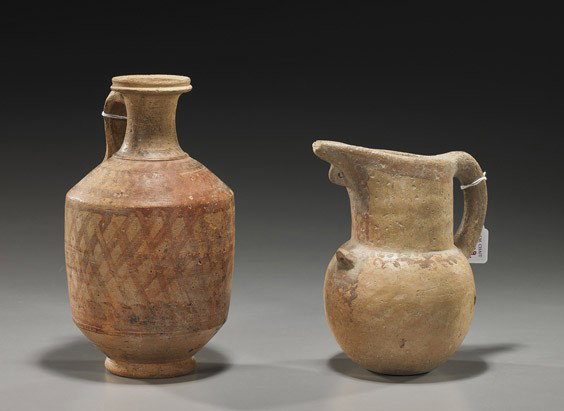 Two Ancient Byzantine Pottery Vessels: Two Ancient Byzantine Pottery Vessels Two ancient Byzantine pottery vessels: footed vase with single handle; and ewer with handle (chip to spout and body chips); some painted decoration to each (typic