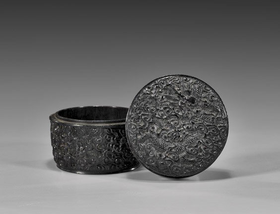 CHINESE CARVED COVERED WOOD BOX: CHINESE CARVED COVERED WOOD BOX Very elaborately carved, Chinese wood box and cover; of cylindrical form, the cover with a writhing dragon: with auspicious design of bats and peaches to the sides, all