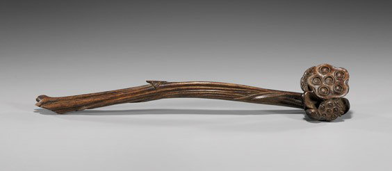 ANTIQUE CARVED EXOTIC WOOD SCEPTER: ANTIQUE CARVED EXOTIC WOOD SCEPTER Antique Chinese carved chenxiangmu wood scepter: of naturalistic form, with lotus pods as the head and undulated stalks at the shaft handle; L: 13 1/2"