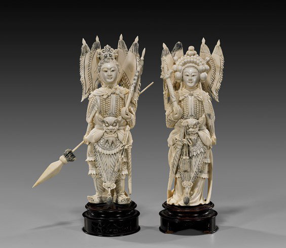 PAIR CARVED IVORY WARRIOR IMMORTALS: PAIR CARVED IVORY WARRIOR IMMORTALS Pair of very elaborately carved, Chinese ivory figures; of a male and female warrior immortal: each in detailed chain-maille armor with flags; male holding a spear 
