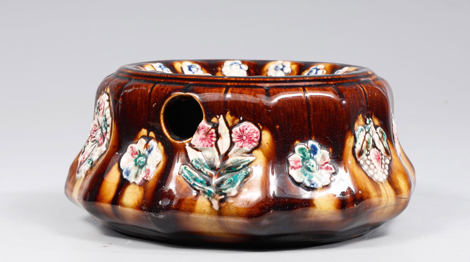 19th Century Ladies Spittoon: Antique 19th century Majolica glaze ladies spittoon with floral motif rosettes around rim and exterior; overall excellent condition, no cracks, no chips, age wear, surface wear; L 7 1/2" H 3 1/2" (App