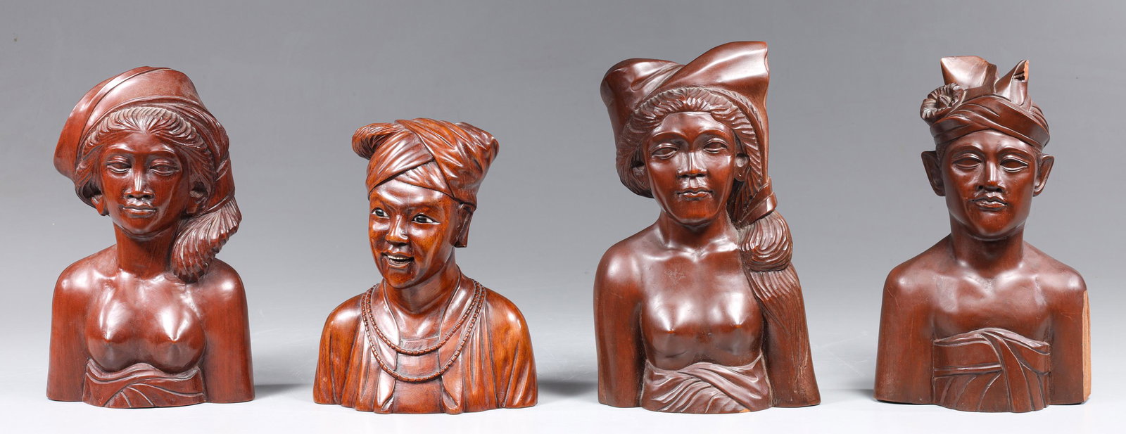 Group of Four Vintage Bali Carved Busts: Group of four vintage Bali carved busts; overall good condition, age wear, surface wear, surface soiling; largest H 10" (Approx.) Provenance: The Stone Collection