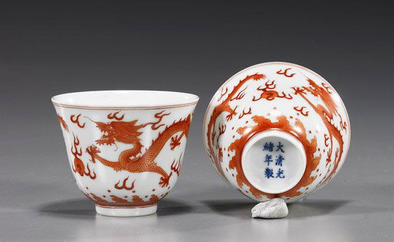 Pair Chinese Porcelain Dragon Teacups: Pair Chinese Porcelain Dragon TeacupsPair Chinese Guangxu-style porcelain tea cups; each with coral red designs of writhing dragons above waves contesting a flaming pearl, 6-character mark to each; D: