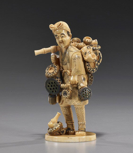 Carved Ivory Okimono: Basket Seller: Carved Ivory Okimono: Basket SellerSectional carved ivory okimono of a basket seller; standing and carrying his wears on a pole across one shoulder, some scrimmed designs to his robes and some polychr