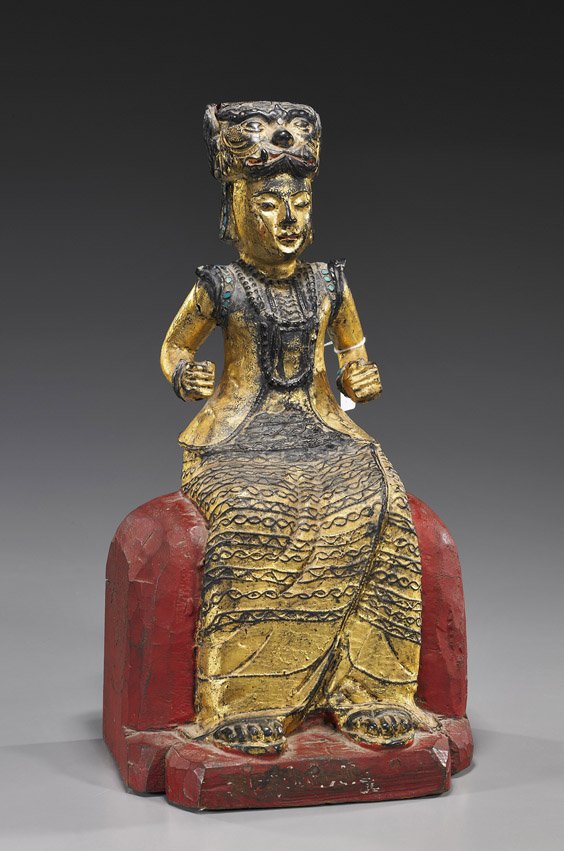 Antique Burmese Lacquered Wood Temple Figure: Antique Burmese Lacquered Wood Temple Figure Antique Burmese gilt and red lacquered wood carving of a seated figure; wearing long detailed and "jeweled" clothing and tiger-like headdress (usual wear, 