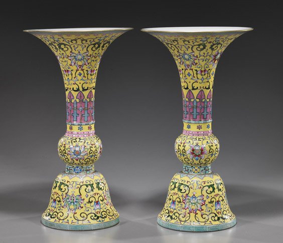 Pair Chinese Famille Rose Porcelain Vases: Pair Chinese Famille Rose Porcelain Vases Pair tall Chinese Qianlong-style Famille Rose porcelain vases; each two-section beaker form with allover colorful Buddhist lotus and scrolling vine motifs on 