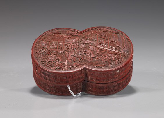 Chinese Carved Cinnabar Lacquer Box: Chinese Carved Cinnabar Lacquer BoxChinese carved Chinese lacquer box and cover; in the form of double coins or the figure eight with scene of figures playing a game in a landscape (crack and flaws);