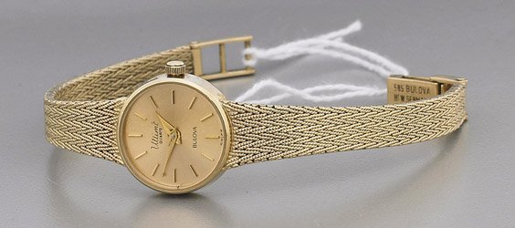 Ladies' Bulova Wrist Watch: Ladies' Bulova Wrist Watch Ladies' 14K yellow gold Bulova Watch Co. Ultimé wrist watch; with round face and matching florentine band; L: 6 1/2"; with original box and paperwork
