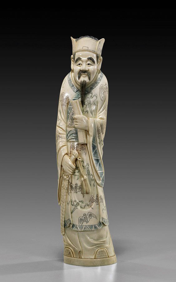 Chinese Polychrome Carved Ivory Sage: Chinese Polychrome Carved Ivory SageChinese carved and lightly polychrome scrimmed ivory figure of a bearded sage; standing in long robes with bat motif, carrying a sword in one hand, a scroll in the