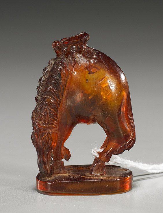 Unusual Carved Amber Netsuke: Horse: Unusual Carved Amber Netsuke: Horse Very unusual carved amber netsuke, probably natural; of a grazing horse with large insect on its back (loss to foot)