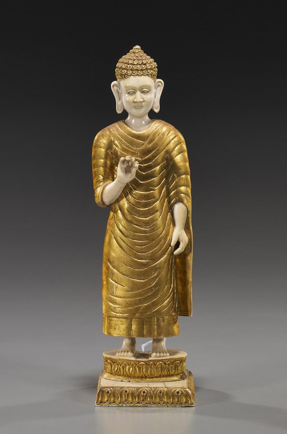 Chinese Carved Ivory Buddhist Figure: Chinese Carved Ivory Buddhist Figure Early 20th Century, Chinese carved and gilt ivory Buddhist figure; standing in long robes atop a raised lotus pedestal, with elongated earlobes and "snail curl" ha