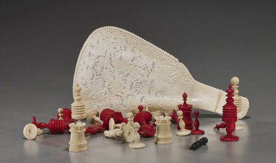 Two Various Asian Bone Carvings: Two Various Asian Bone CarvingsTwo various bone carvings: Indonesian fan with figural and openwork designs; together with an old Indian partial chess set, some red lacquered, 33 pieces total; L: 11 3/