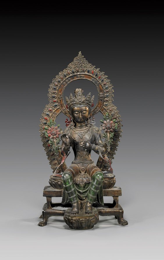 Large Sino-Tibetan-Style Bronze Deity: Large Sino-Tibetan-Style Bronze Deity Large Sino-Tibetan-style bronze, parcel gilt and partial enameled Buddhist deity: seated on a stylized lotus pedestal atop a throne-type bench and with feet resti