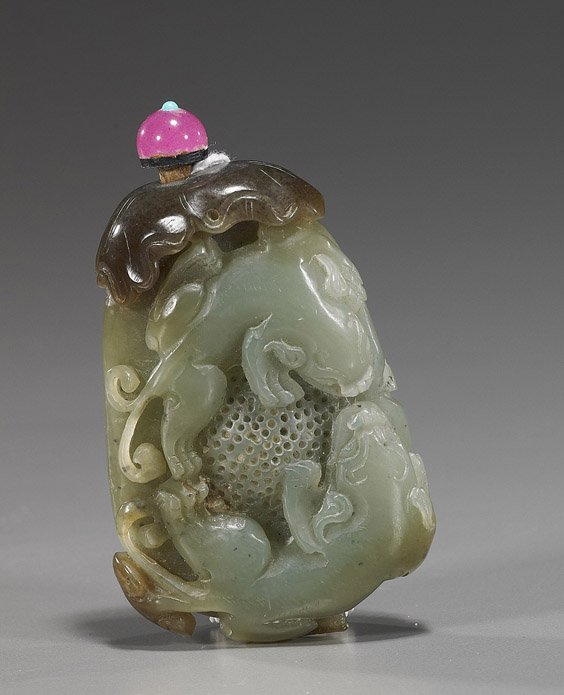 Chinese Carved Celadon Jade Snuff Bottle: Chinese Carved Celadon Jade Snuff Bottle Unusual and very elaborately carved, Chinese celadon and brown jade snuff bottle; with design of two lion-type animal in relief to the front, verso with ruyi o