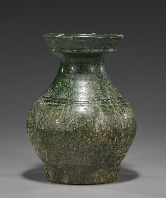 Han Dynasty Green Glazed Pottery Vase: Han Dynasty Green Glazed Pottery Vase Chinese Han Dynasty, green glazed pottery hu-form vase; with wide rim and decorative bands at the shoulder (some glaze degradation and minor chips); H: 8 1/4"