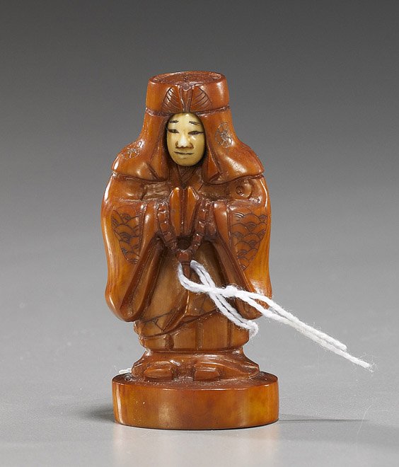 Unusual Carved Ivory Okimono: Turn-Face: Unusual Carved Ivory Okimono: Turn-Face Unusual, carved and stained ivory netsuke sized okimono: of a priest in long robes and headdress, standing and holding beads, with turn-face; H: 2 1/2"