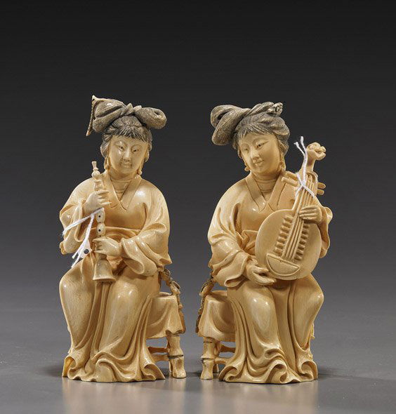 Two Chinese Carved Ivory Musicians: Two Chinese Carved Ivory MusiciansTwo Chinese carved and lightly stained ivory musician beauties; each seated on a stool and wearing long robes: one carrying a stringed ruan instrument; the other with