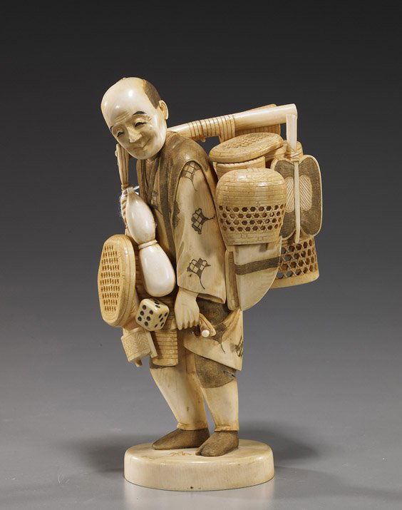 Carved Ivory Okimono: Basket Seller: Carved Ivory Okimono: Basket SellerElaborately carved, sectional ivory okimono; of a basket seller, standing and carrying his wares on a pole across one shoulder, signed (some losses); H: 8 1/2"