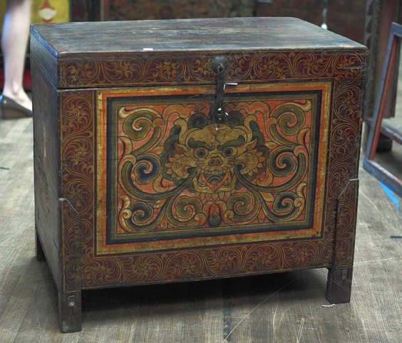 Two Tibetan/Mongolian Painted Chests: Two Tibetan/Mongolian Painted Chests Two elaborately painted, Tibetan or Mongolian chests: one with bronze hardware and hinged top, the front with design of a dragon's face and gilt foliate border (we