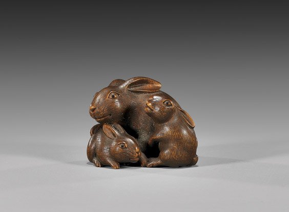 ANTIQUE WOOD NETSUKE: Three Rabbits: 木製根付 ANTIQUE WOOD NETSUKE: Three Rabbits Very finely carved, antique wood netsuke; of three rabbits, all with inlaid eyes, signed Shinzan in oval reserve