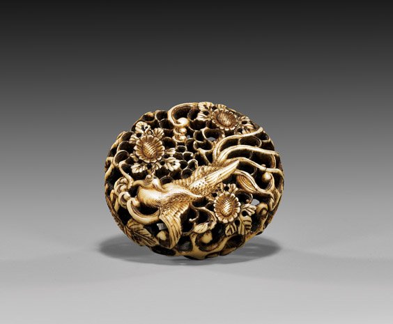 ANTIQUE RYUSA MANJU NETSUKE: 饅頭根付 ANTIQUE RYUSA MANJU NETSUKE Beautifully detailed and openwork reticulated, antique ryusa manju netsuke; depicting a phoenix amid large blossoms, unsigned; 19th Century