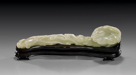 CHINESE CARVED CELADON JADE SCEPTER: 青玉雕靈芝如意 CHINESE CARVED CELADON JADE SCEPTER Naturalistically carved, Chinese carved celadon jade ruyi scepter: with relief design of lingzhi fungus and