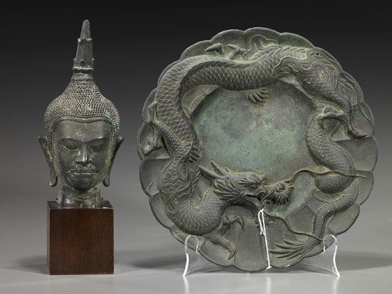 Two Chinese Bronzes: Dish & Buddha Head: Two Chinese Bronzes: Dish & Buddha HeadTwo Chinese bronzes: foliate dish/plaque with writhing dragon in relief (some chips); together with Thai-style Buddha head with elongate earlobes and flaming ush