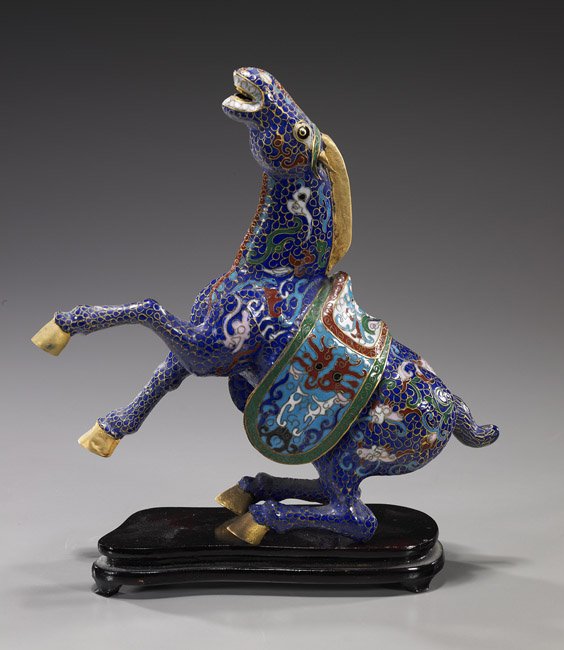 Chinese Cloisonné Enamel Rearing Horse: Chinese Cloisonné Enamel Rearing Horse Chinese cloisonné enamel model of a Tang-style horse; rearing up and with allover colorful archaistic motifs on blue ground; H: 9", wood stand
