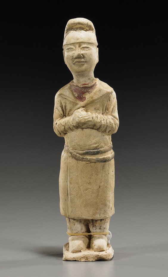 Sui Dynasty Pottery Tomb Figure: Sui Dynasty Pottery Tomb Figure Chinese Sui Dynasty pottery tomb figure; of a standing mourner wearing typical belted cloak and cap, with hands joined at the chest (wear and some old repair); H: 8 3/4