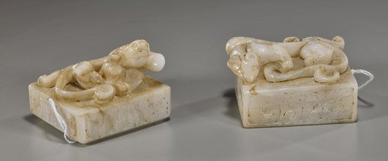Two Chinese Carved White Jade Seals: Two Chinese Carved White Jade Seals Two Chinese carved white jade seals; nearly a pair (one larger) each square form with writhing hydra on top; L: 3" (larger); Provenance by repute: purchased from Ba