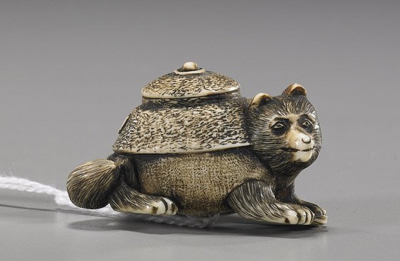 Carved Ivory Netsuke: Teapot Badger: Carved Ivory Netsuke: Teapot Badger Carved and stained ivory netsuke; of a recumbent teapot bagger: finely detailed, signed, early 20th Century; L: 1 1/2"