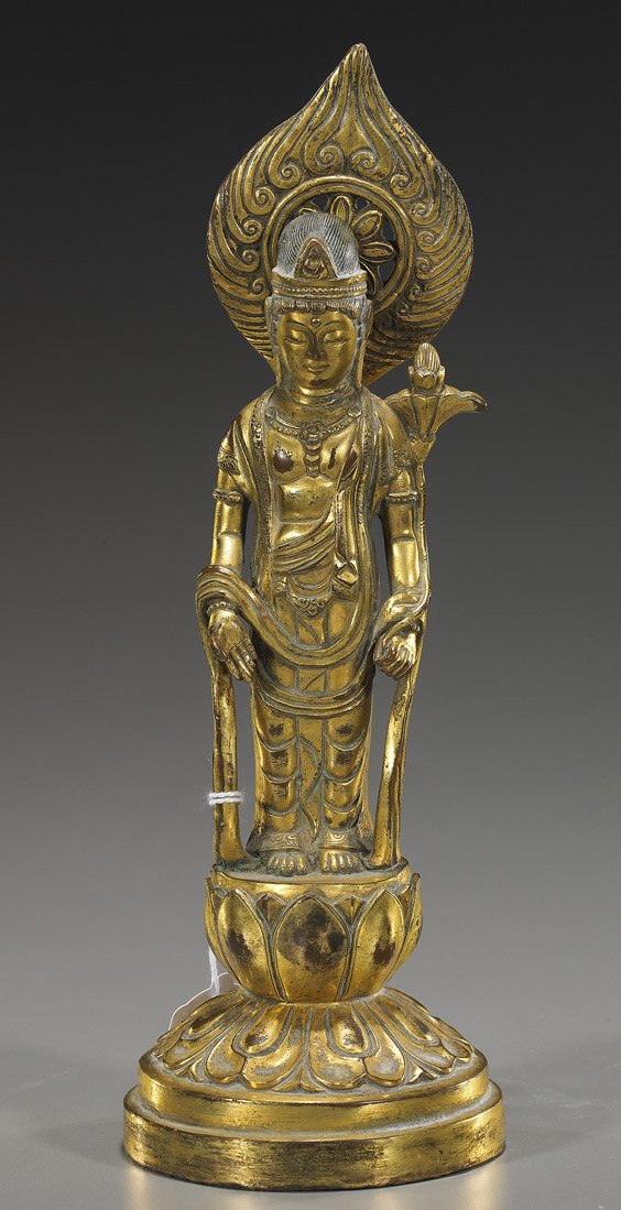 Chinese or Sino-Tibetan Gilt Bronze Deity: Chinese or Sino-Tibetan Gilt Bronze Deity Chinese or Sino-Tibetan gilt bronze Buddhist deity; standing on a raised stylized lotus pedestal: wearing long robes and headdress, holding a lotus in one han