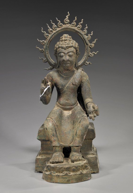 Southeast Asian Bronze Buddha: Southeast Asian Bronze Buddha Southeast Asian bronze Buddha: seated on a square plinth with feet resting on a lotus stand; hands in mudra and with a flaming mandorla behind, Ayutthaya-style; H: 19 1/2