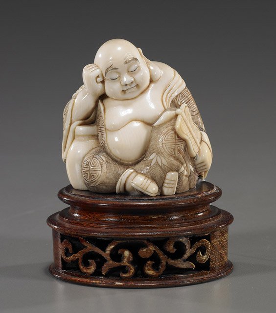 Old Carved Ivory Okimono: Sleeping Hotei: Old Carved Ivory Okimono: Sleeping Hotei Very well carved and old, Japanese ivory okimono; of a seated sleeping Hotei, leaning against a jar and holding a fan, finely scrimmed robe, signed; H: 2 3/8",