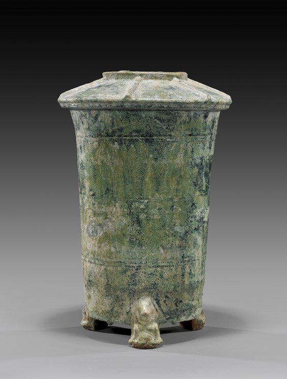 HAN DYNASTY GLAZED POTTERY GRANARY: 漢 三足帶蓋陶器 HAN DYNASTY GLAZED POTTERY GRANARY Chinese Han Dynasty, archaic pottery model of a granary; of cylindrical form with a flared top: standing on