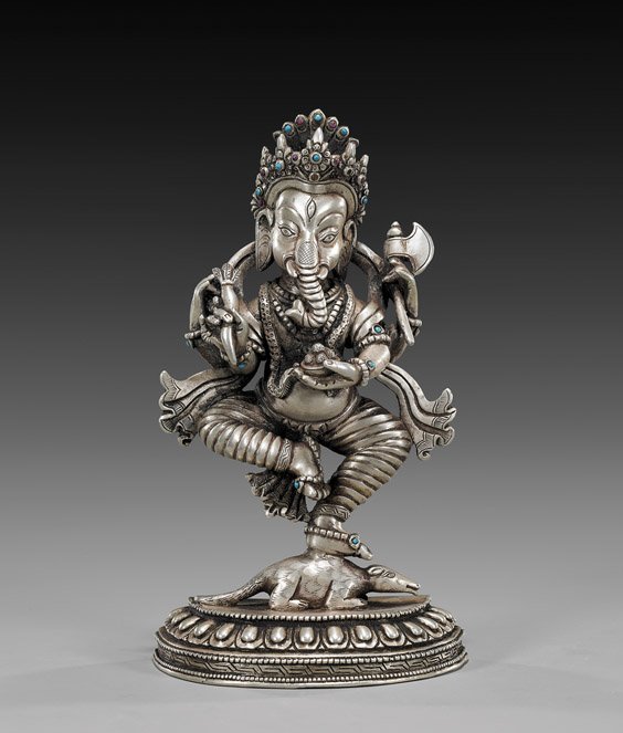 NEPALESE SOLID SILVER GANESHA: 尼泊爾鑄銀象頭神 NEPALESE SOLID SILVER GANESHA Nepalese solid cast silver figure; of Ganesha, wearing an ornate crown: holding several emblems and stand