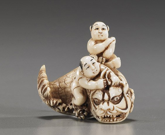 Carved Ivory Netsuke: Figures & Dragon Fish: Carved Ivory Netsuke: Figures & Dragon Fish Well detailed, carved and lightly stained ivory netsuke; depicting 2 figures riding on a dragon-fish, signed; Provenance: de-accessioned from Los Angeles Co