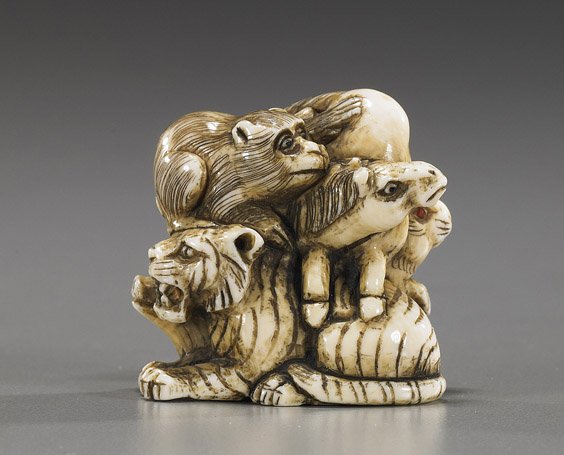 Carved Ivory Netsuke: Animal Group: Carved Ivory Netsuke: Animal Group Carved ivory netsuke; of a group of various zodiac animals, including: monkey, horse, tiger, rabbit and pig; all piled atop one another, signed, some with inlaid eye